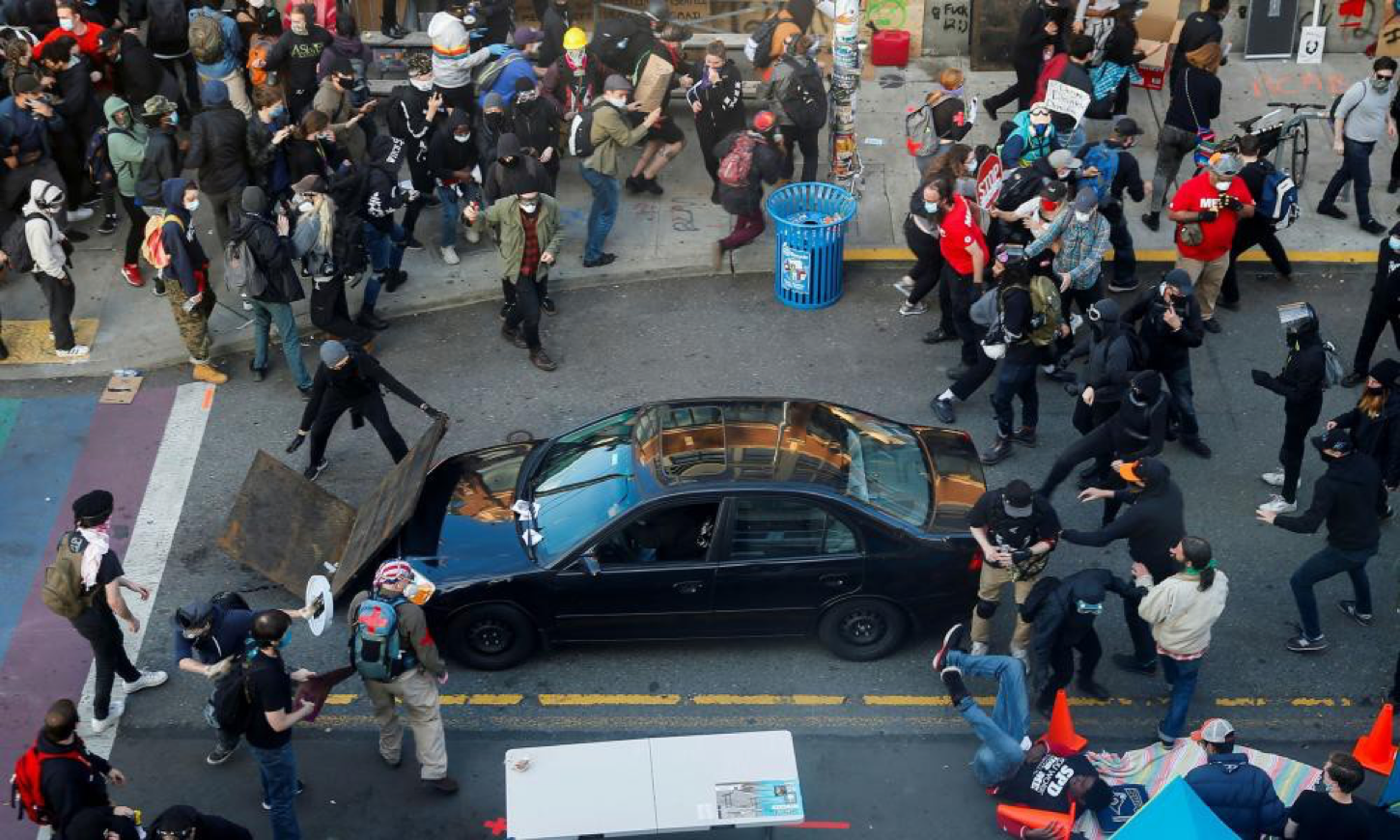 You are currently viewing Protesters across US attacked by cars driven into crowds and men with guns